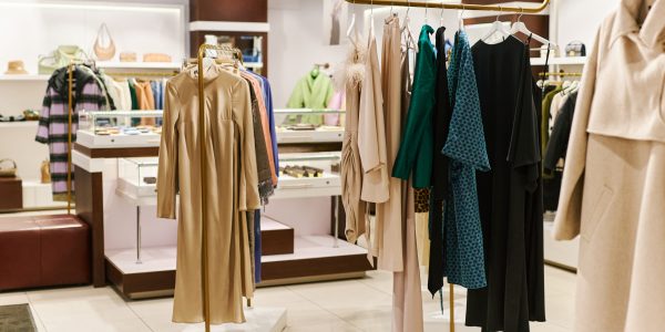 Background image of luxury clothing boutique interior at shopping mall, copy space