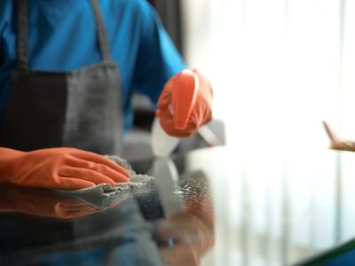 closeup-woman-in-rubber-gloves-wiping
