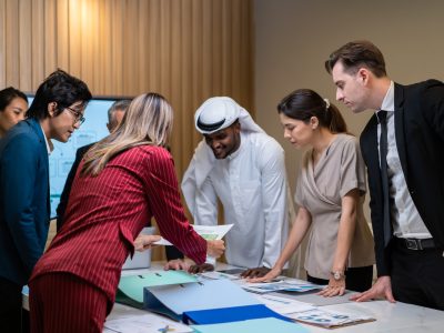 Group of multi-Ethnic businessman and businesswoman working in office. Attractive employee brainstorm and meeting as team, plan and discuss project in workplace. Corporate of modern colleagues concept